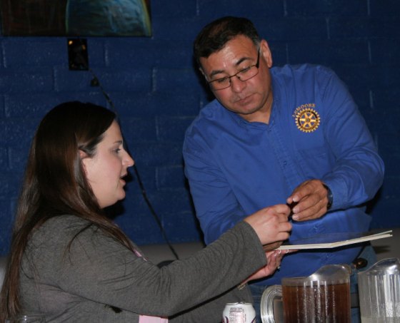 Rotary President Jesus Garcia presents Lemoore City Manager Andi Welsh with final payment for downtown arbor project.